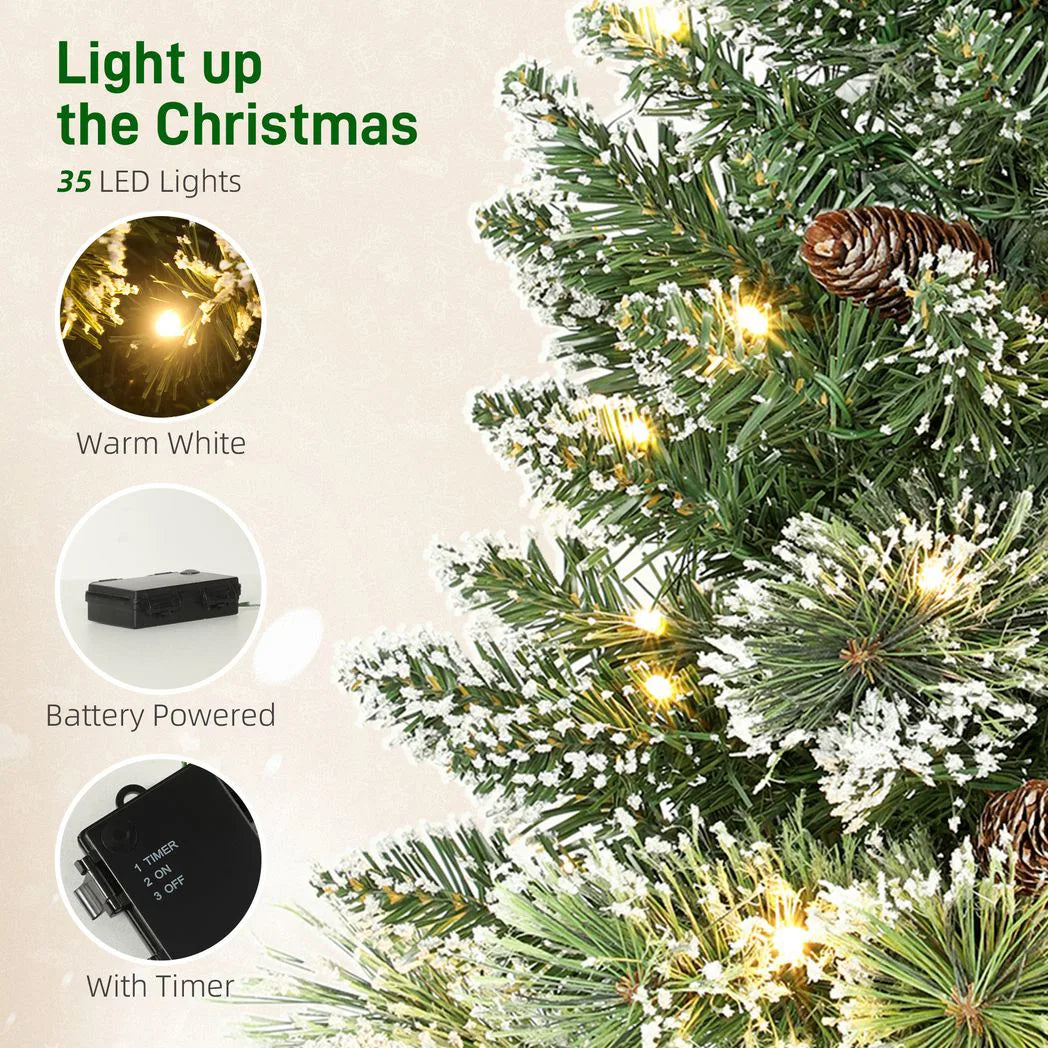 HOMCOM 60 cm Prelit Small Christmas Tree, Snow Flocked Tabletop Mini Xmas Tree with 35 LED Lights, Pine Cones and Linen Cover Base, Battery Operated, Green